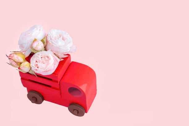 istock Red wooden car with flowers. 1258094954