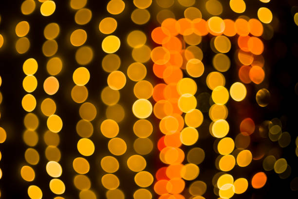 istock Christmas home room with tree and festive bokeh lighting, blurred holiday background 1258096586