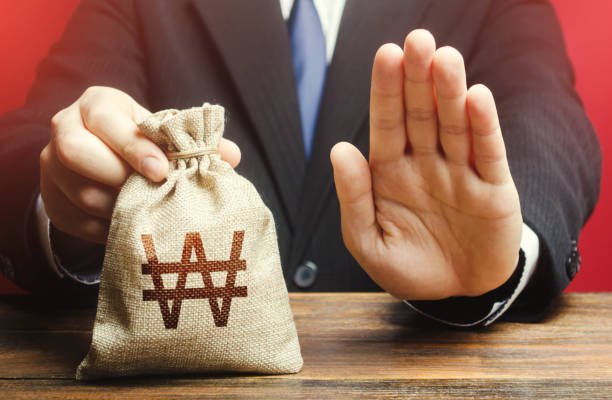 istock Businessman refuses to give south korean won money bag. Stop financing projects and reforms, crisis financial difficulties. Loan refusal, bad credit history. Asset freeze. Payment refund. Deception 1258097604