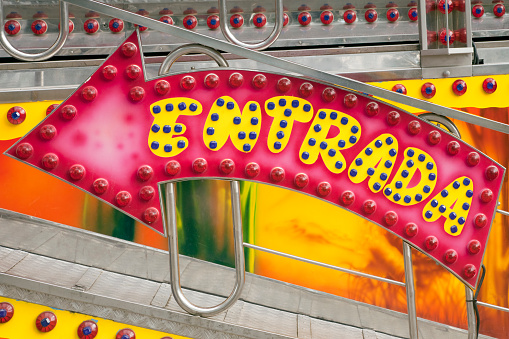 Way in sign in Amusement park ride,fair, illumination equipment close-up view,  spanish language .  San Froilán traditional festival,  Lugo city, Galicia, Spain.