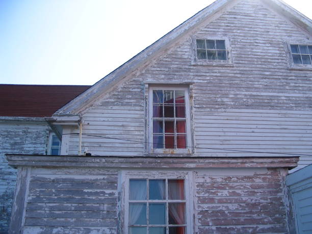 istock Weathered lighthouse building with red lighthouse reflection in Twillingate Newfoundland 2005 1258099949