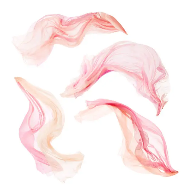 Photo of Fabric Cloth Pieces Flying on Wind, Set of Flowing Fluttering Pink Silk, on White