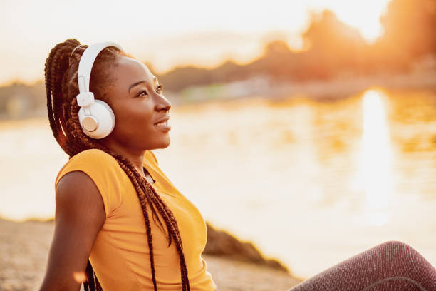 istock Young woman is relaxing by the river 1258107954