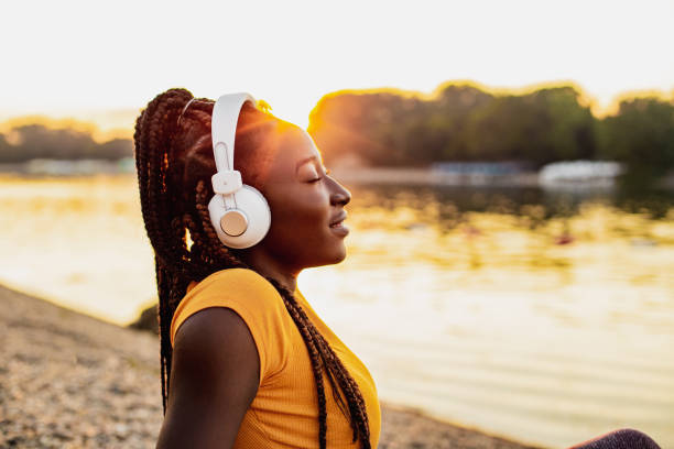 istock Young woman is relaxing by the river 1258107986