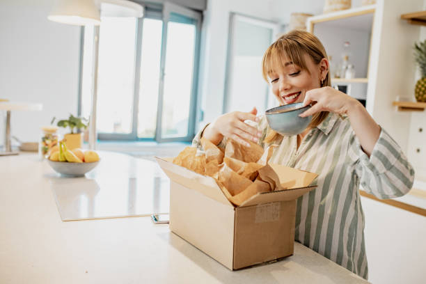istock Young woman unpack the package she ordered online 1258109652