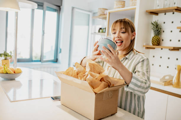 istock Young woman unpack the package she ordered online 1258109653
