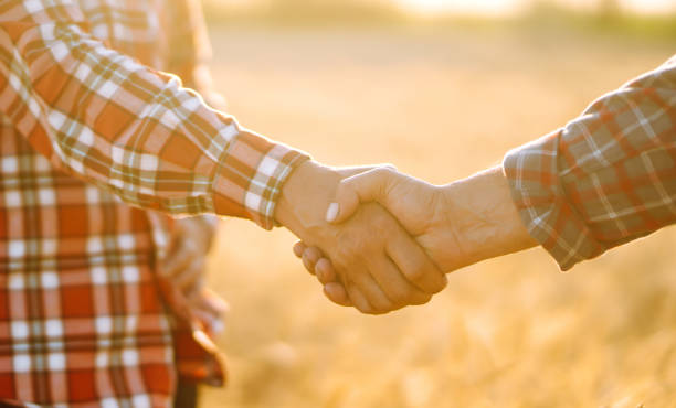istock Handshake of  two farmer. 1258112614