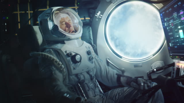 Astronaut Sitting Inside a Space Rocket During Take Off. Successful Rocket Launch Sending Space Ship into Space. Cosmonaut Experiencing G-Force and Vibrations Inside Capsule. Clouds Pass in Porthole.