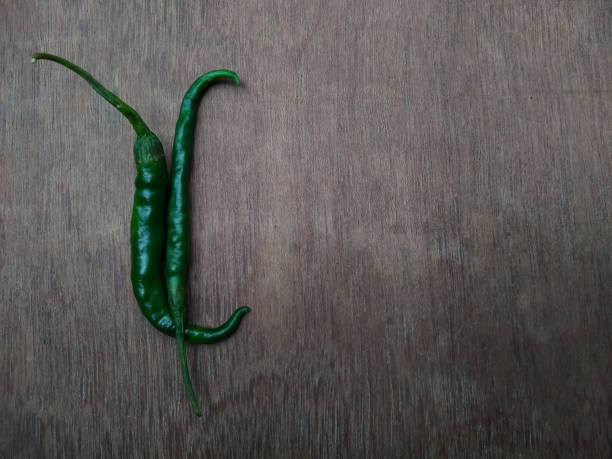istock Green chillies on a wooden table 1258113464