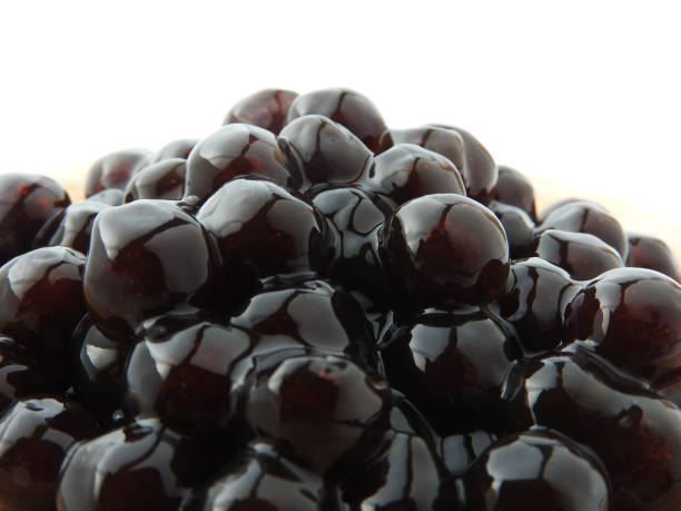 istock Front view and close up of black tapioca ball (also known as boba in bubble tea) which is ingredients for making pearl milk tea, other Taiwanese drink and shaved ice at dessert shop. Food background. 1258113833