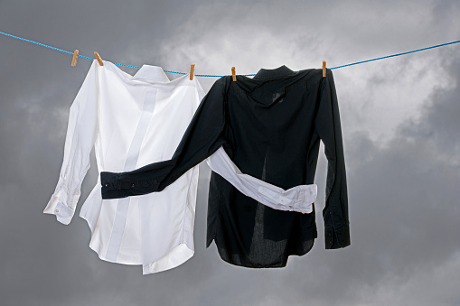 Clean laundry hanging on a clothesline. No racism Concept. Book Cover.
