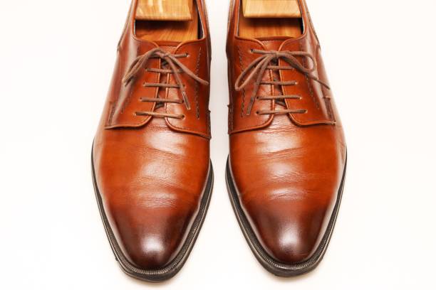 istock White background and brown leather shoes. 1258114849