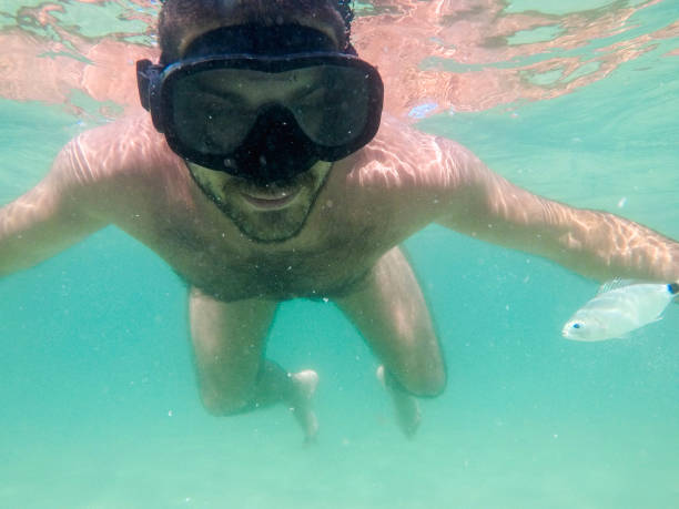 istock Boy dives into the sea 1258114891