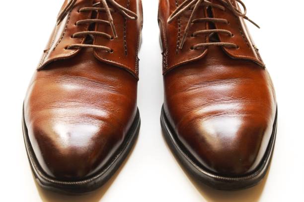 istock White background and brown leather shoes. 1258114936
