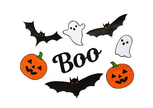 Carved scary figurines of Boo, ghosts, pumpkins and bats on a white background, the concept of the holiday Halloween. High quality photo