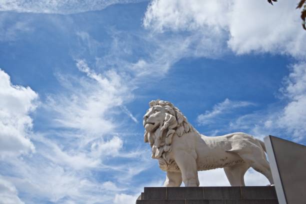 istock Lion statue with blue sky and cloud background at London - England. 1258120214