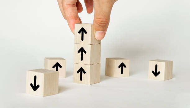 istock Hand arranging wood block stacking as step stair with arrow up. Ladder career path concept for business growth success process 1258121005