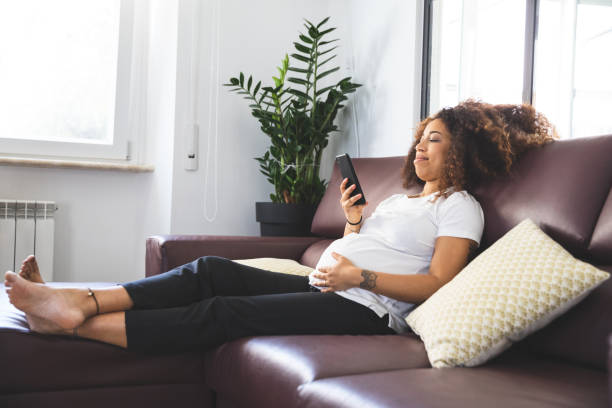 istock Pregnant woman relaxing on the sofa 1258121612