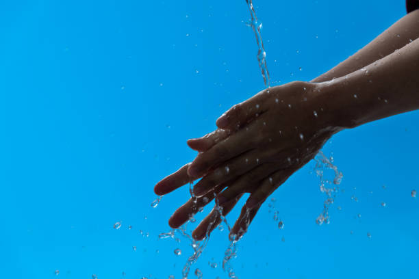 istock Woman washing hands under flowing water 1258121668