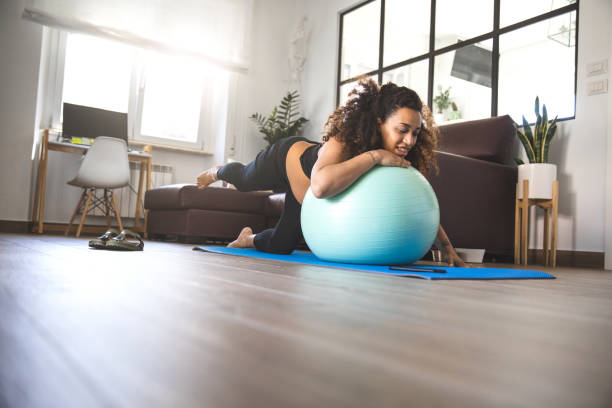 istock Pregnant woman practicing Yoga at home 1258121752