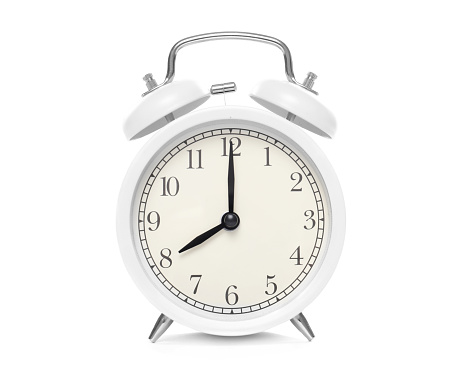A black alarm clock featuring two bells on top, chrome handle, and legs, captured against a pristine white background. The design blends classic elegance with modern functionality, creating a visually appealing timepiece.