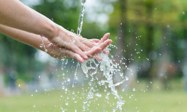 istock Woman washing hands under flowing water 1258122929