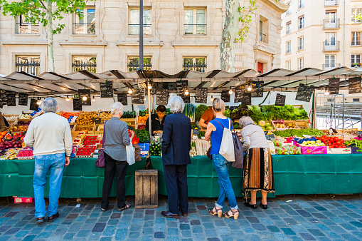 Paris, France - Apr 20, 2019 - Traditional food market in Paris during sunny morning