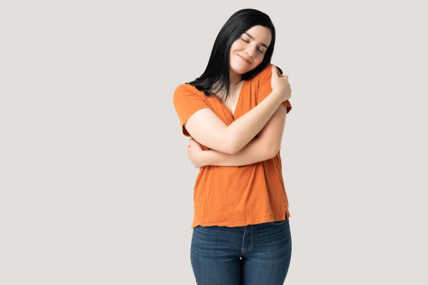 istock Smiling Pretty Woman Embracing Herself 1258125242