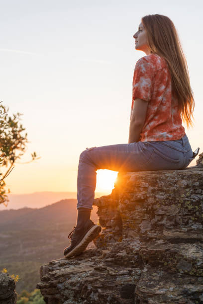 istock Young woman enjoying the sunset 1258125247