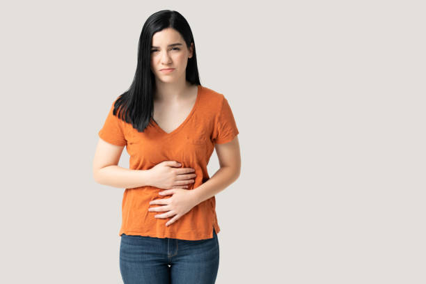 istock Young Woman Suffering From Stomachache 1258125254