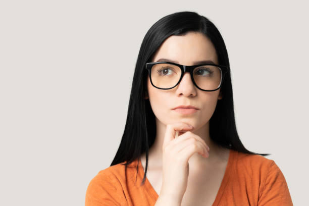 istock Pretty Woman Thinking With Hand On Chin 1258125327