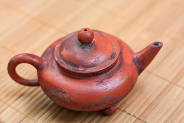 istock old brown ceramic teapot on bamboo Mat. 1258126183