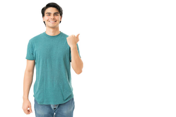 istock Happy Hispanic Young Man Showing Blank Space 1258126361