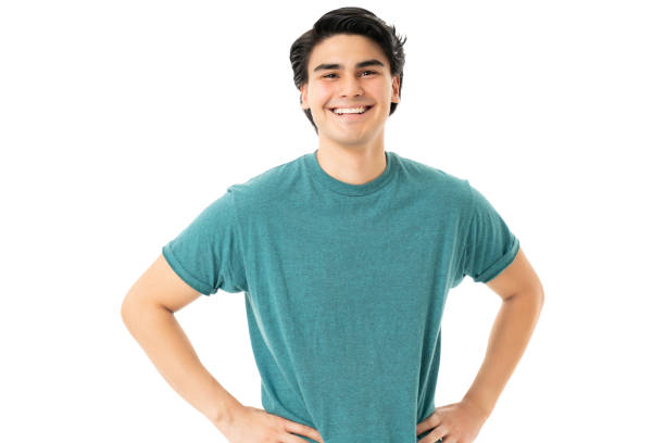 istock Smiling Handsome Man Standing With Arms Akimbo 1258126406