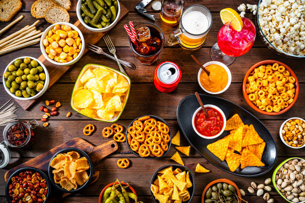 istock Party table with salty snacks and drinks 1258127387