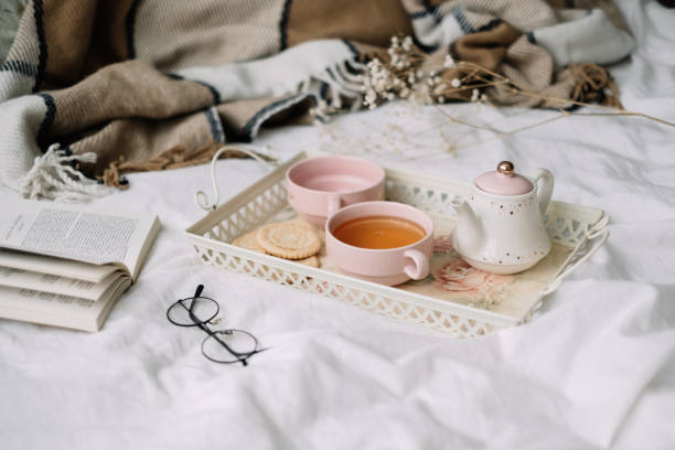 istock Kettle with tea and cups on a tray. Breakfast at home in bed, coziness. 1258127701