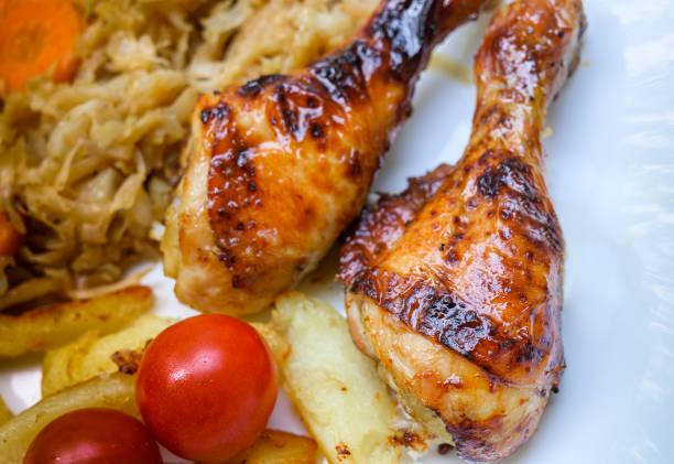 istock Roasted chicken leg with cherry tomato.Top view. 1258129936