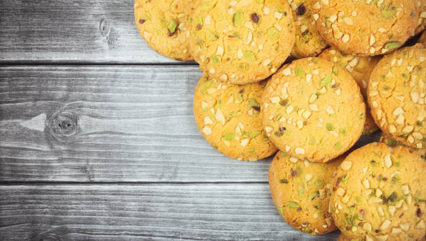 istock Home made sweet biscuits with mixed nuts on wooden table 1258131933