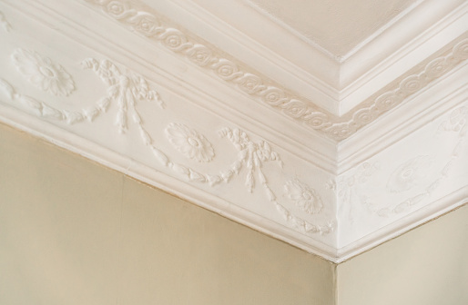 A typical old fashioned patterned cornice between the interior wall and ceiling in a European house.