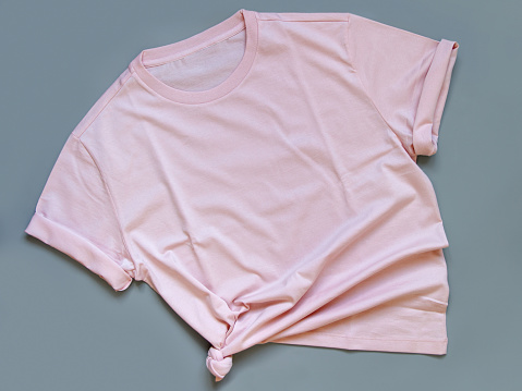 Pink t-shirt mock up flat lay on grey background top view