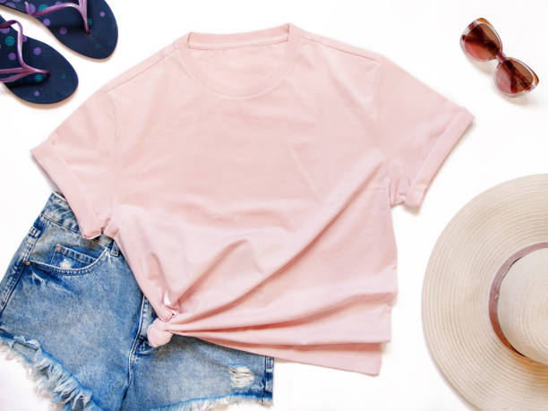 istock Mockup of a pink t-shirt placed between some beach accessories 1258133105