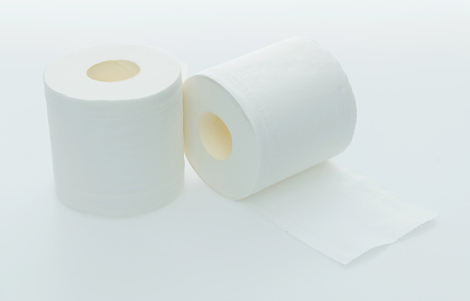 Two rolls of white toilet paper on white background.