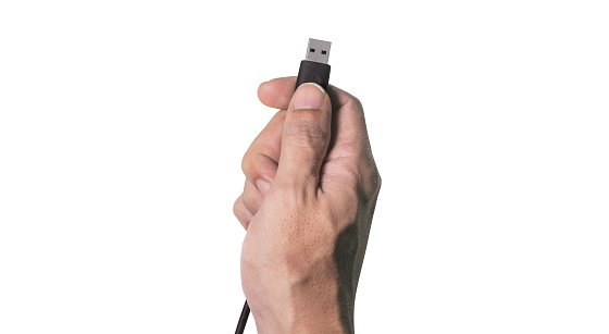 Close up shot, Man hand showing the black USB data cable, ready to connect the computer gesture, isolated on white background.