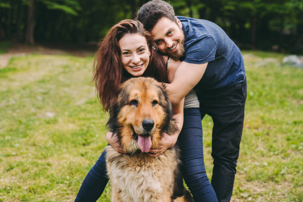 istock Young couple with dog 1258135500