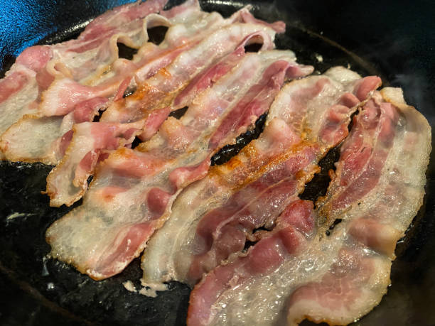 istock Bacon Cooking in Cast Iron Skillet 1258136794