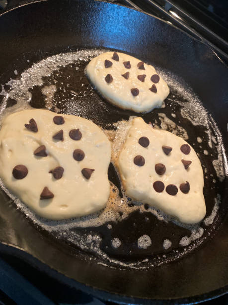 istock Chocolate Chip Pancakes Cooking in Cast Iron Skillet 1258136990