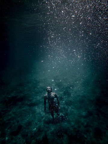 Man floating underwater
