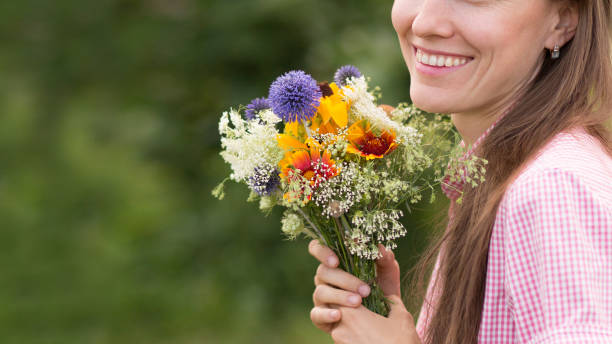 istock young woman with flowers 1258139205