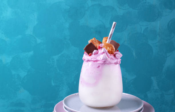 istock Milkshake topped with pink whipped cream and different cookies 1258139364