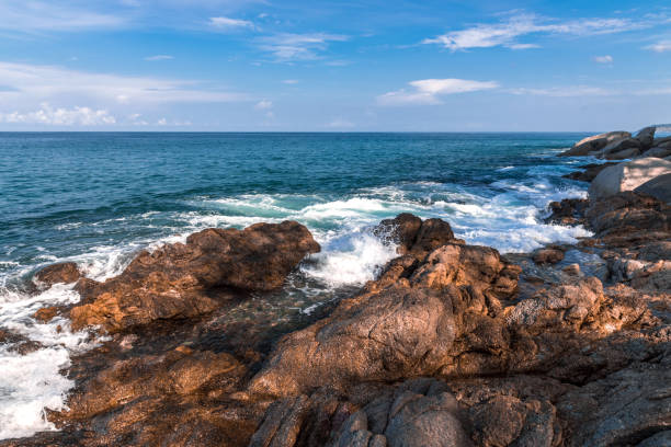 istock Rocky shore of the ocean with breaking waves 1258139462